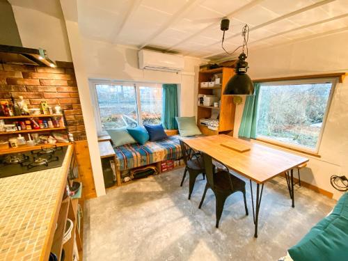 a living room with a table and a couch at Kojohama base - Vacation STAY 89929v in Shikyū