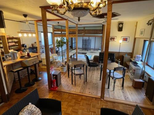 a living room with a table and chairs and a dining room at Tanonagano Yadokko - Vacation STAY 62252v in Goshogawara