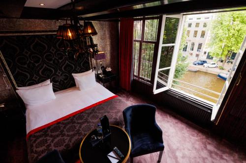 a hotel room with a bed and a window at The Pavilions Amsterdam, The Toren in Amsterdam