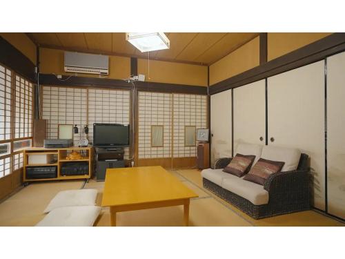 a living room with a couch and a tv at Oasis Minamiboso - Vacation STAY 04559v in Minamiboso