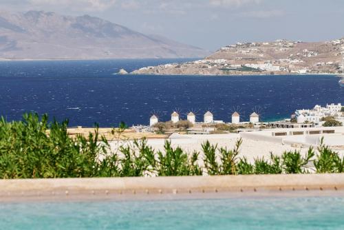 a view of a beach with the ocean in the background at Myconian Naia - Preferred Hotels & Resorts in Mýkonos City