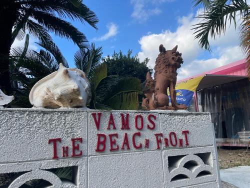 a sign for a beachfront resort with statues on it at VAMOS the Beach Front - Vacation STAY 05356v in Tokunoshima