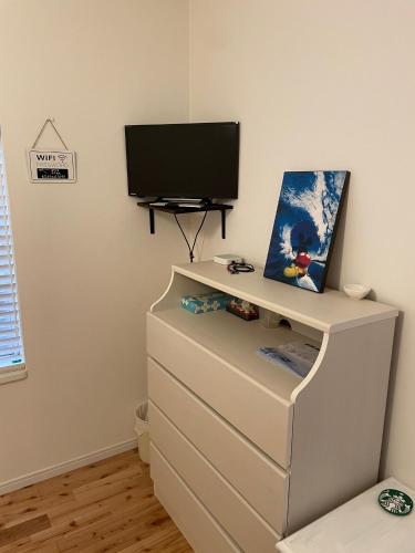 a white dresser with a television on top of it at VAMOS the Beach Front - Vacation STAY 05356v in Tokunoshima