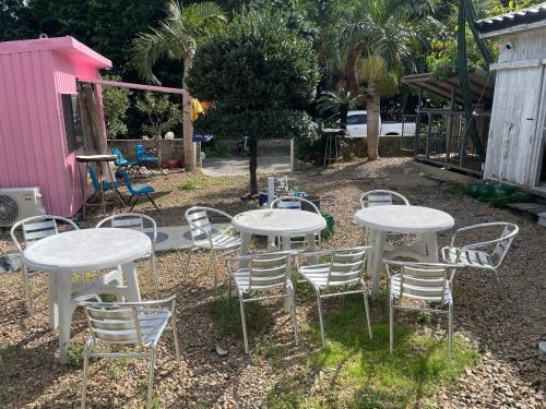 a group of white tables and chairs in a yard at VAMOS the Beach Front - Vacation STAY 05356v in Tokunoshima