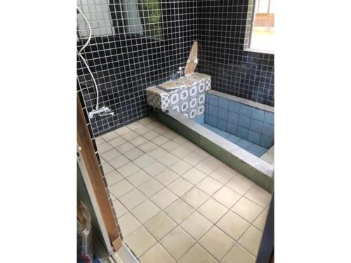 a bathroom with a shower with a tiled floor at Hinata Sanso - Vacation STAY 02668v in Azumino