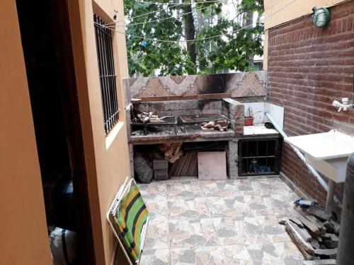a kitchen with a fireplace in a brick wall at Monoambiente San Bernardo in San Bernardo