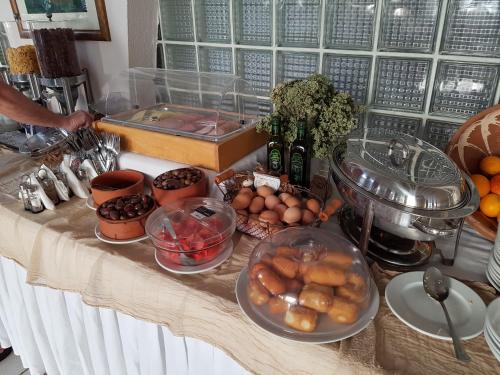 a counter top with a bunch of food on it at Apollon Hotel in Ancient Epidavros