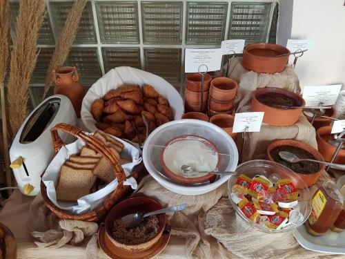 a table topped with lots of different types of food at Apollon Hotel in Ancient Epidavros