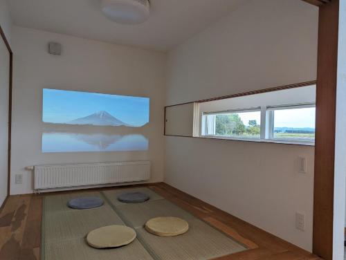 a room with two large windows and two mats on the floor at One House Naganuma MAOI - Vacation STAY 09878v in Naganuma