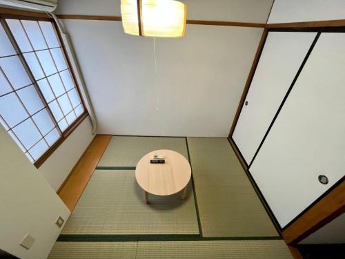 a table in the middle of a room with windows at Yuzawa House - Vacation STAY 07080v in Yuzawa