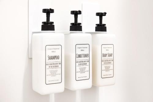 a group of three white soap dispensers in a bathroom at VOGUE C, a private inn with a panoramic view of th - Vacation STAY 14693v in Isumi