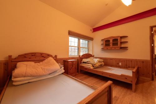 a bedroom with two beds and a window at Yubari Shikanotani residence - Vacation STAY 16529 in Yubari