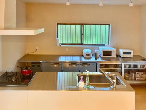 a kitchen with a sink and a counter top at Yoronto - Vacation STAY 18850v in Yoron