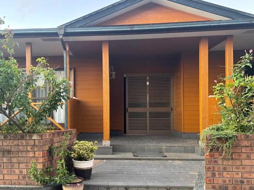 a house with a front door with plants in front at Yoronto - Vacation STAY 18850v in Yoron
