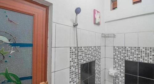 a bathroom with a shower with a glass door at OYO Life 92127 Skyland Pasteur in Bandung