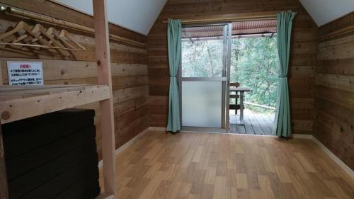 a log cabin with a fireplace and a dining room at Ryujin Village Oku-Komatagawa Bungalow - Vacation STAY 42247v in Ōkuma