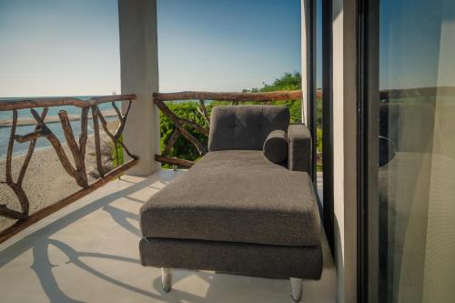 a chair sitting on top of a balcony at MUUN Beach Club in Ciudad del Carmen