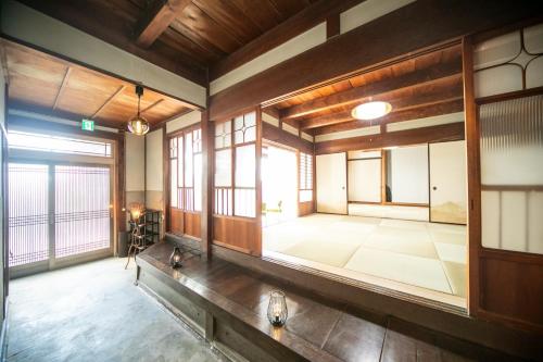 an empty room with a large room with windows at Kominka Besso - Vacation STAY 15819 in Kuwana