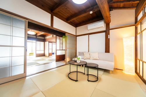 a living room with a table and a couch at Kominka Besso - Vacation STAY 15819 in Kuwana