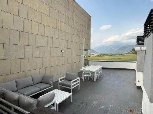 a patio with a couch and chairs and a table at Luminoso 3 Rooms Vistas Pirineo in Sabiñánigo