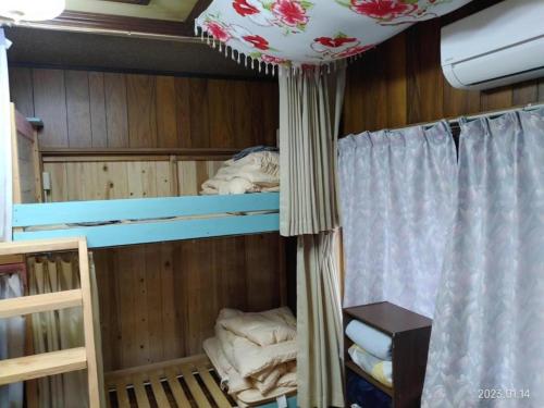 a room with two bunk beds and a curtain at ImagineWestOcean - Vacation STAY 15909 in Suo Oshima