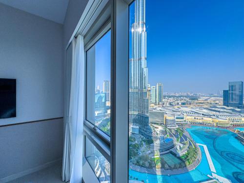 a room with a window with a view of a city at GRANDE RESIDENCES with a direct Burj Khalifa view and Private Fountain Show at 62nd floor with DXB AIRPORT VIP Shuttle option for 8 guests in Dubai