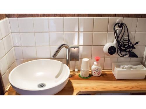 a bathroom with a white sink in a room at Shingu Guest House Sou - Vacation STAY 16376v in Shingu