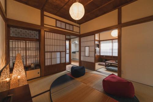 an asian room with a chandelier and a room with at Jyokanoyado tomoshibi - Vacation STAY 15868 in Ōzu