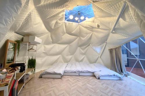 a bed in a tent with a ceiling with a clock at Yamaga City - Camp - Vacation STAY 42290v in Kurize