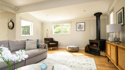 a living room with a couch and a wood stove at Ashbourne Farmhouse Near Woodend in Ashbourne