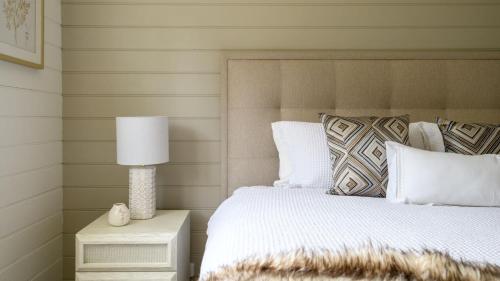 a bedroom with a bed and a lamp on a nightstand at Ashbourne Farmhouse Near Woodend in Ashbourne