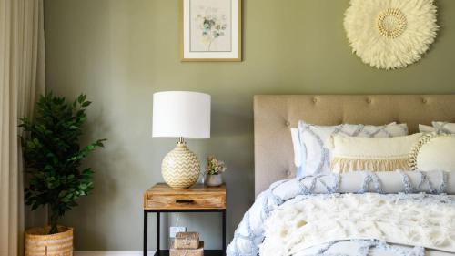 a bedroom with a bed and a table with a lamp at Ashbourne Farmhouse Near Woodend in Ashbourne