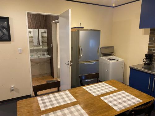 a kitchen with a table and a refrigerator at Kami no Tsuki - Vacation STAY 15816 in Akiruno