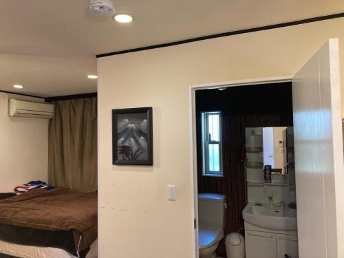 a room with a bedroom with a bed and a bathroom at Kami no Tsuki - Vacation STAY 15816 in Akiruno