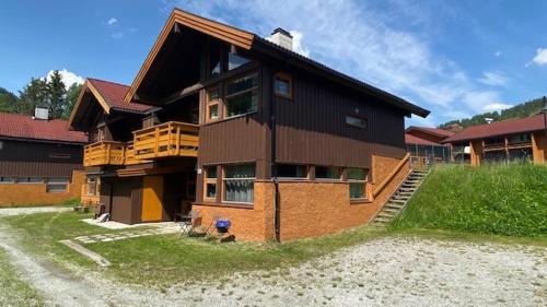 a large house is sitting on top of a field at Actif 413 - apartment close to Ål Ski Centre in Ål