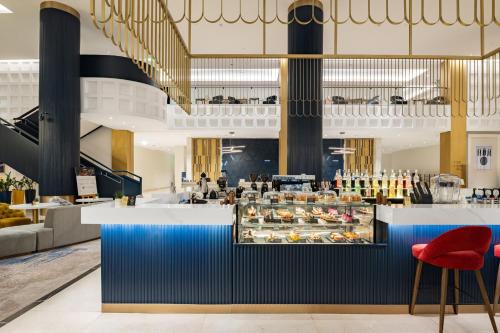 a view of the lobby of a restaurant with a counter at voco Jeddah Gate by IHG in Jeddah