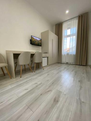 an empty living room with a table and chairs at Hotel U Radnice Aš in Aš