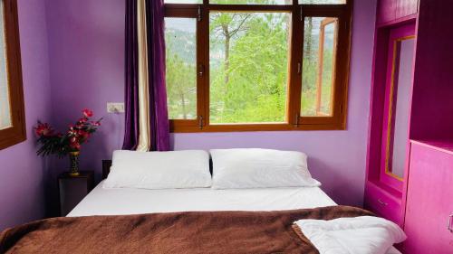 a purple room with a bed and a window at Mayank homestay shimla in Shimla