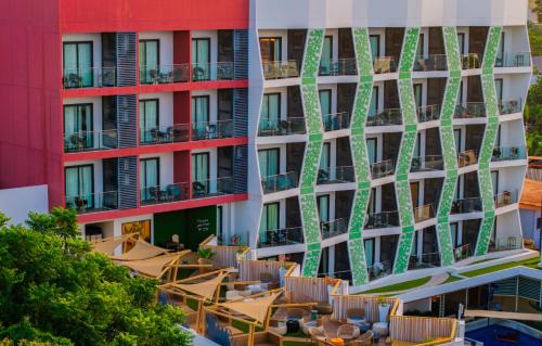 a building with tables and chairs in front of it at Best Western Plus The Ivywall Resort-Panglao in Panglao