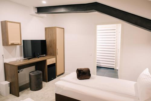 a bedroom with a bed and a tv and a mirror at The Butterfly in Sîngeorgiu de Mureş