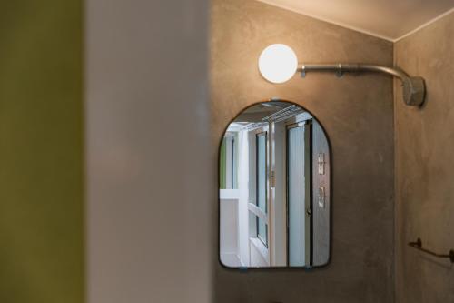 a mirror on a wall in a bathroom at 博多の旅籠 すノや in Fukuoka