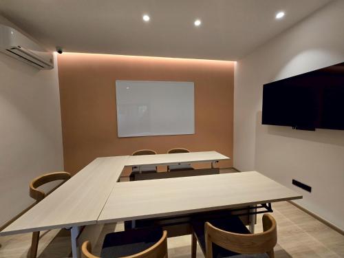 a conference room with a table and a flat screen tv at PAAK Hotel Suvarnabhumi in Lat Krabang