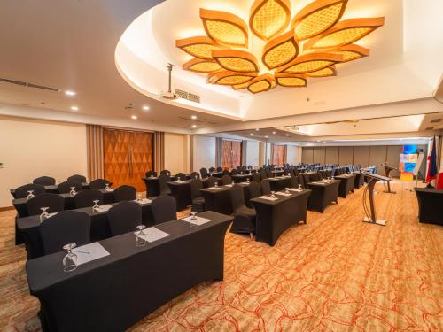 a conference room with chairs and a large chandelier at Best Western Plus The Ivywall Resort-Panglao in Panglao