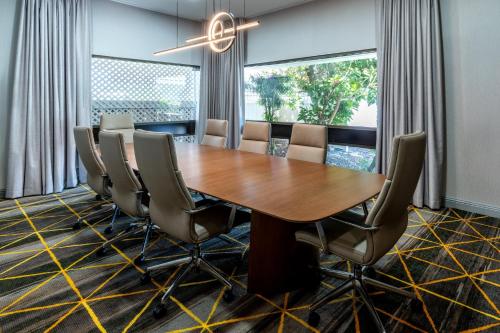 a conference room with a wooden table and chairs at Holiday Inn Dublin - Pleasanton by IHG in Dublin