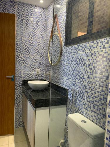 a bathroom with a sink and a toilet at ALIZE CUMBUCO in Cumbuco