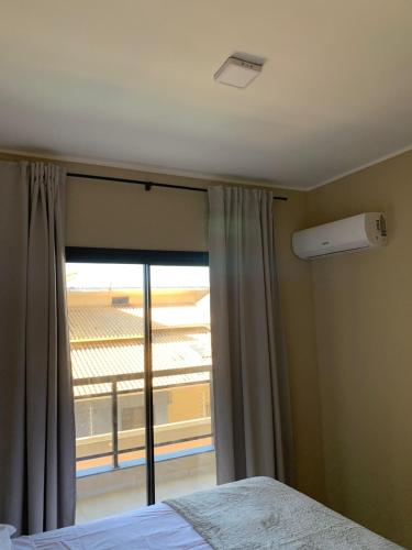 a bedroom with a window with a view at ALIZE CUMBUCO in Cumbuco
