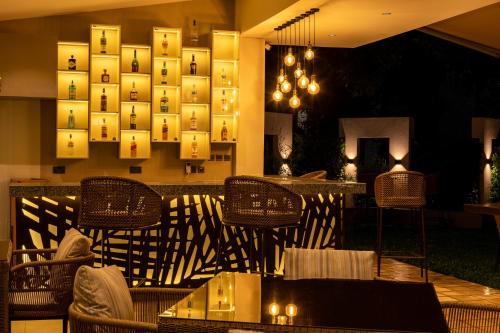 a restaurant with chairs and tables and a wall with lights at Bidwood Suite Hotel in Nairobi