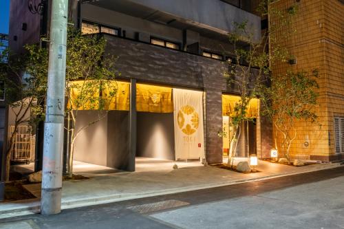 a store front of a building at night at Hotel TOKI 季 in Tokyo