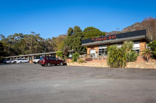 a car parked in a parking lot in front of a motel at The Grampians Motel in Halls Gap