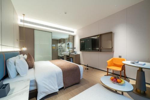 a hotel room with a bed and a table at Yizhi Hotel - Guangzhou Shamian Island Huangsha Metro Station-Canton Fair free shuttle bus included Breakfast in Guangzhou